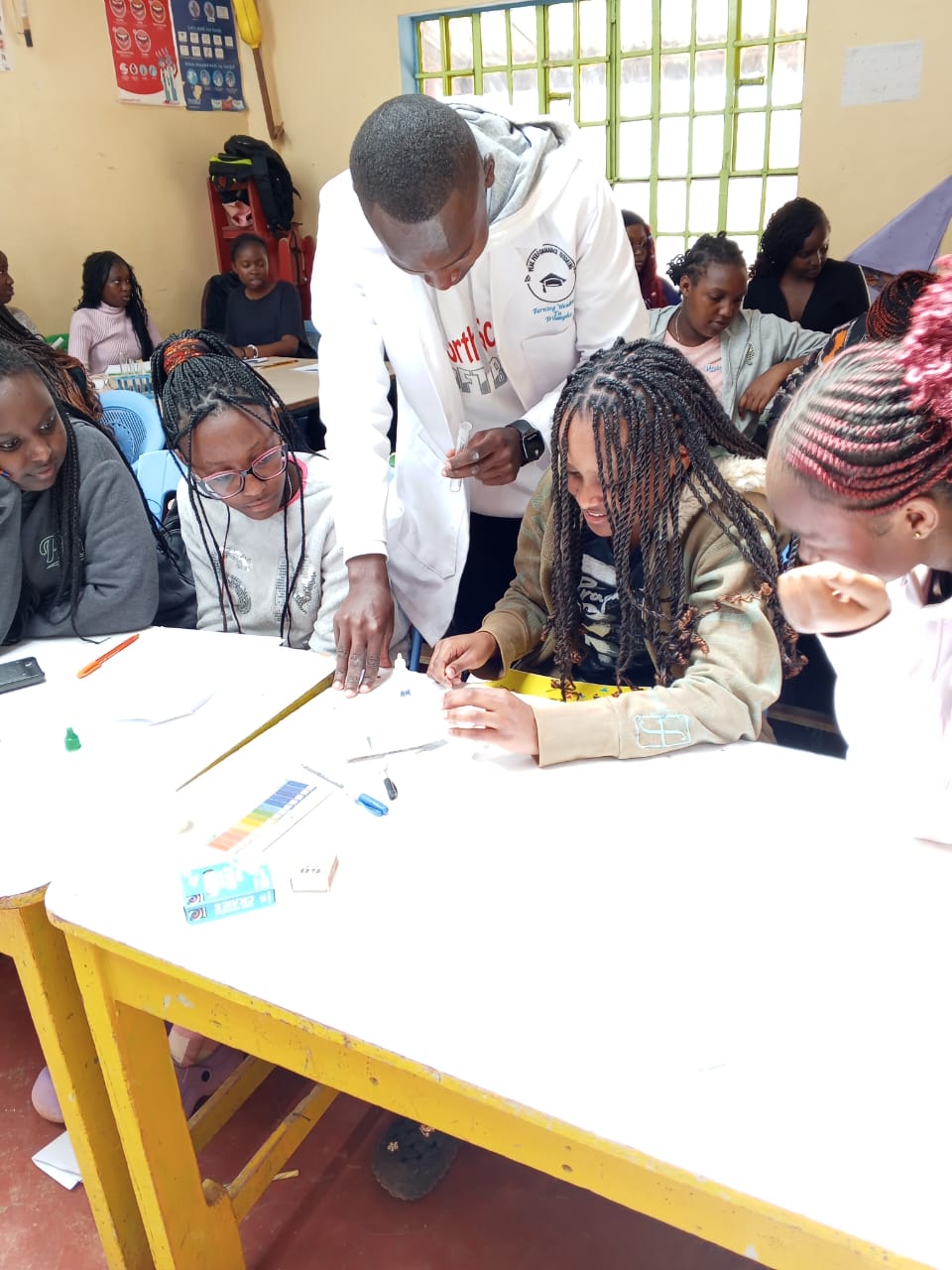 A Peak Campus teacher giving one-on-one practical guidance to a learner